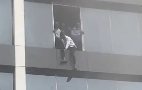 People trying to escape from a building on fire