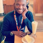 #OurFavOnlineDoc’ Olufunmilayo Ogunsanya Ex, Bola Aseyan Tells FIJ How He Got Her Drunk And Violated Her (Part 1 of 3) a smiling male sitting at a table