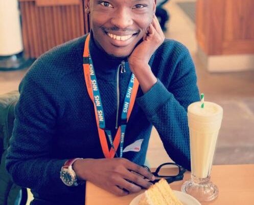 a smiling male sitting at a table