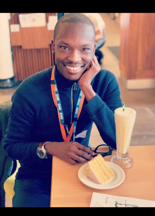 a smiling male sitting at a table