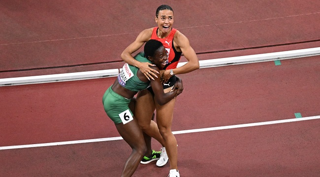 two athletes in emotional embrace after a race