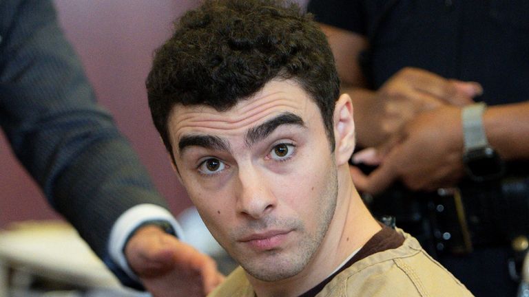 Caucasian male in prison outfit appearing in court