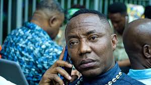 An African male with a phone in his hands to his ears