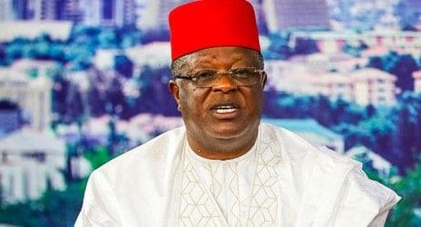 male with a red cap holding the office of Nigerian minister for Works