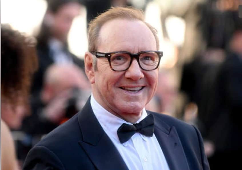 Hollywood actor in a suit and spectacles